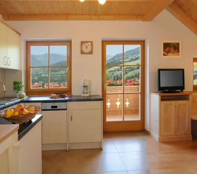 a kitchen with a view of a mountain at Linderhof in Bressanone