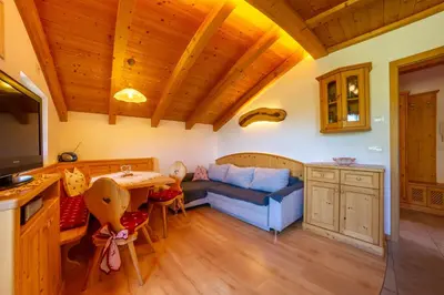 a living room with a couch and a table at Linderhof in Bressanone