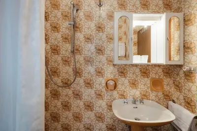 a lamp on a night stand next to a bed at Residence Arche Noah - Colfosco in Colfosco