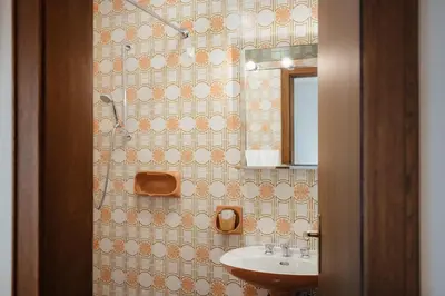 a kitchen with orange cabinets and a sink at Residence Arche Noah - Colfosco in Colfosco