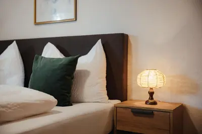 a hotel room with a bed and a table and a window at Residence Arche Noah - Colfosco in Colfosco