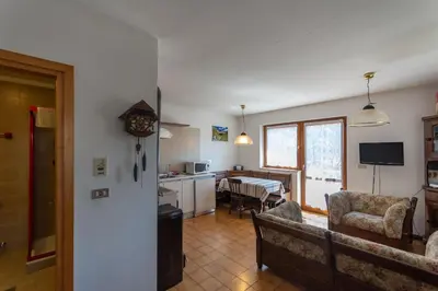 a living room with a couch and a dining room at Dimora al Villaggio in Campestrin