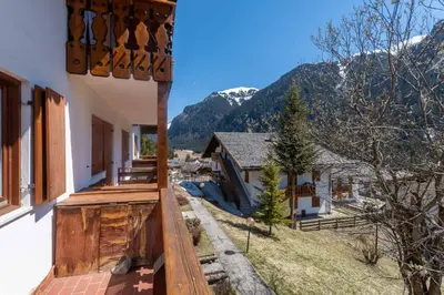 a balcony of a house with mountains in the background at Dimora al Villaggio in Campestrin