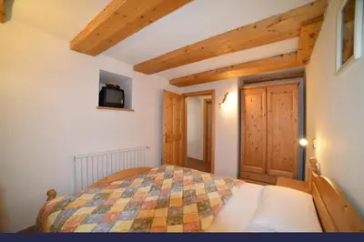 a bedroom with a bed in a room with wooden ceilings at Casa De Guidi in Meida