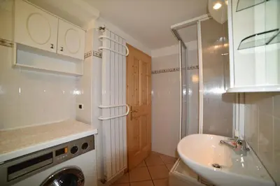a bathroom with a sink and a washing machine at Casa De Guidi in Meida