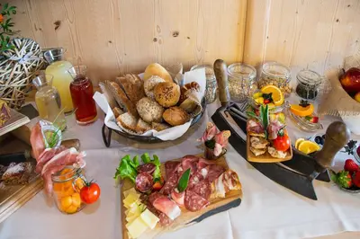 a table with many different types of food on it at Haidgerberhof - apartments & homemade food in Longomoso
