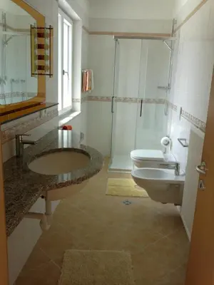 a bathroom with a sink and a toilet and a shower at Vermietung Obermais in Merano