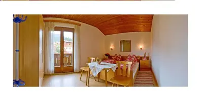 a living room with a table and a couch at Appartments Geislerblick in Castelrotto