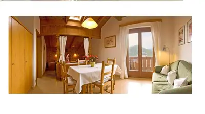 a kitchen and dining room with a table and chairs at Appartments Geislerblick in Castelrotto