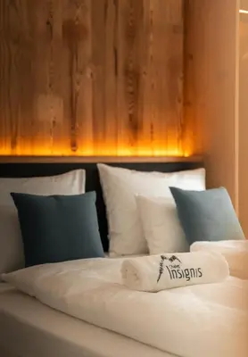 a bed with a towel on top of it at Chalet Insignis in Santa Cristina in Val Gardena