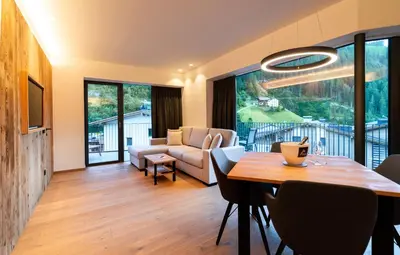 a living room with a table and a couch at Chalet Insignis in Santa Cristina in Val Gardena
