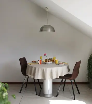 a table with a plate of food on it at Theatre Lodge Attico teatro in Merano