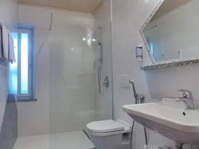 a bathroom with a shower and a sink and a toilet at Ferienwohnungen Braiter in Rifiano