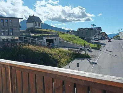 a view of a street with a house on a hill at LA PULCE INNEVATA - mansarda sulle piste, Dolomiti Affitti in Passo Rolle