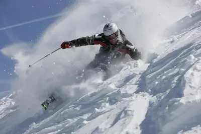 a person is skiing down a snow covered slope at Suite Cima Pape in Rocca Pietore