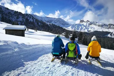 three people sitting in the snow on a mountain at App Schlossblick - Wohnung Hammerwand 2 in Umes