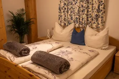a bed with two pillows on top of it at App Schlossblick - Wohnung Hammerwand 2 in Umes