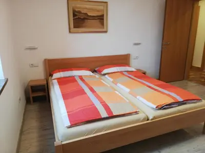 a bed with two pillows on it in a room at Haus Möltner - Apartment Aviam in Caldaro