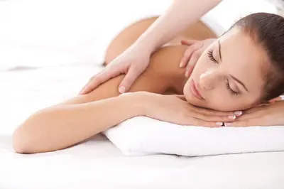 a woman getting a massage from a towel at Berghotel Jochgrimm - Your Dolomites Home in Varena
