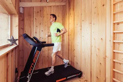 a man standing on a treadmill in a gym at Berghotel Jochgrimm - Your Dolomites Home in Varena