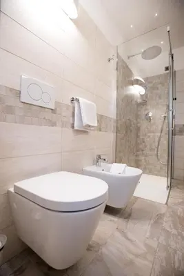 a bathroom with a toilet and a sink and a shower at Appartamenti Cèsa Crepa Neigra in Canazei