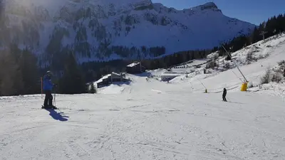 two people are skiing down a snow covered mountain at Casa AQ28 sulle piste da sci in Falcade