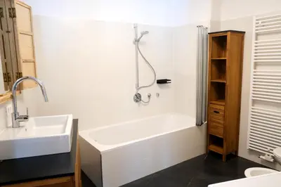 a bathroom with a white tub and a sink at Apartment Plantitsch - Alpstay in Naturno