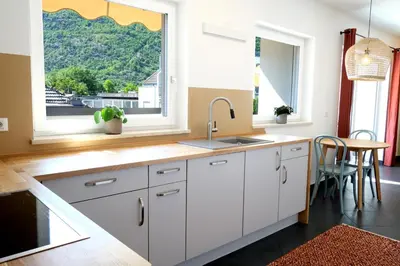 a kitchen with white cabinets and a sink and a window at Apartment Plantitsch - Alpstay in Naturno