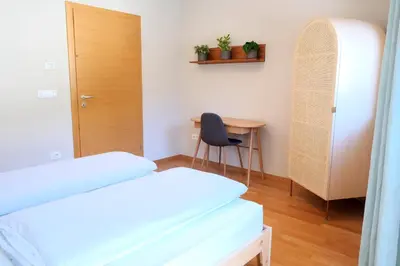 a bedroom with a desk and a bed and a chair at Apartment Plantitsch - Alpstay in Naturno