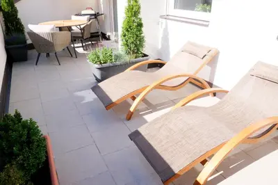 a patio with two chairs and a table and a table at Apartment Plantitsch - Alpstay in Naturno