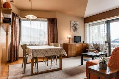 a living room with a dining room table and a couch at Residence Greymold in Rifiano