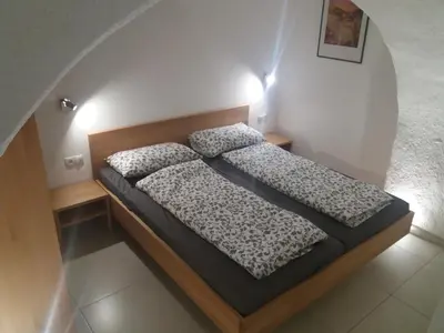 a small bedroom with a bed in a room at Haus Möltner - Apartment 1927 in Caldaro