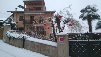 a house with a fence in the snow at Haus Möltner - Apartment 1927 in Caldaro