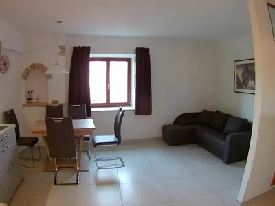 a living room with a couch and a table at Haus Möltner - Apartment 1927 in Caldaro