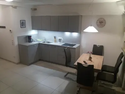 a small kitchen with a table and a sink at Haus Möltner - Apartment 1927 in Caldaro