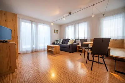 a living room with a couch and a table at The Muse Apartments in Selva di Val Gardena