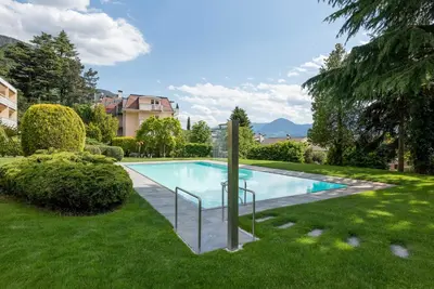 a swimming pool in the middle of a yard at Fior Apartments Pienzenau in Merano