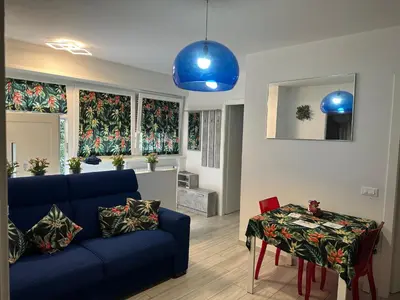 a living room with a blue couch and a table at Manuel's Home 1 FREE parking Wi-Fi AC in Bolzano