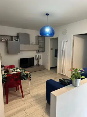 a living room with a table and a blue light at Manuel's Home 1 FREE parking Wi-Fi AC in Bolzano