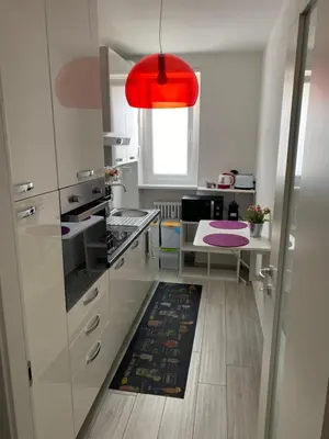 a kitchen with white cabinets and a red light at Manuel's Home 1 FREE parking Wi-Fi AC in Bolzano