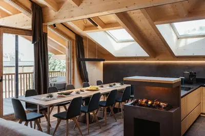 a dining room with a fireplace and a table and chairs at Chalet Dolecir in La Valle