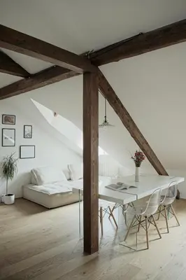 a white dining room with a table and a couch at Design Apartment in the heart of Bolzano in Bolzano