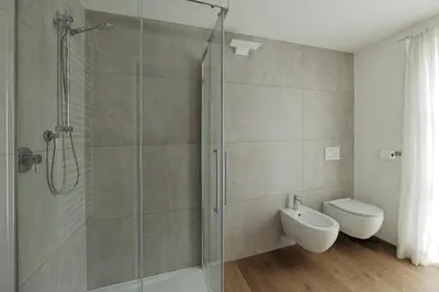 a bathroom with a shower and a toilet and a sink at Design Apartment in the heart of Bolzano in Bolzano