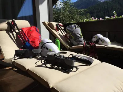 a group ofhelmets and helmets sitting on a balcony at Crioli Dolomiti Lodge in Villabassa