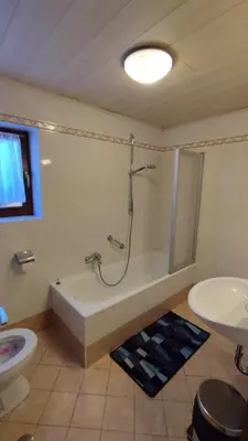 a bedroom with a bed with towels on it at Ciasa Rosada in San Vigilio Di Marebbe
