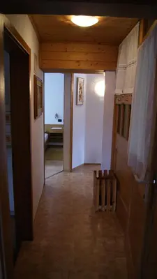 a hallway with a hallway leading to a room at Ciasa Rosada in San Vigilio Di Marebbe