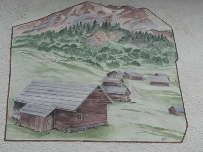 a painting of a village on the wall at Ciasa Rosada in San Vigilio Di Marebbe