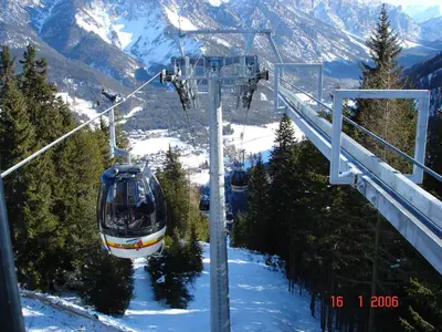 a ski lift going up a snow covered mountain at Ciasa Rosada in San Vigilio Di Marebbe