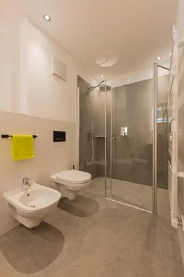 a bathroom with a toilet and a glass shower at Residence Bergheim in Braies