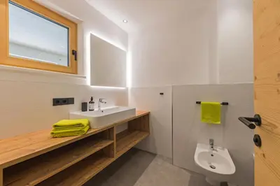 a bathroom with a sink and a toilet at Residence Bergheim in Braies